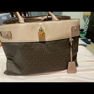 MK brown/pink Medium purse with cross body strap .